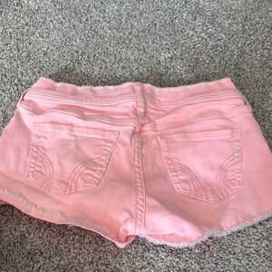 Pink Jean Shorts with Frayed Hem and Distressed Style